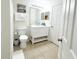 Bright bathroom featuring tile floors, a vanity, and coordinated white fixtures at 150 Barefoot Beach Way, Kissimmee, FL 34746