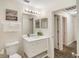 Bright bathroom featuring a toilet, sink, granite counters, and a shower at 150 Barefoot Beach Way, Kissimmee, FL 34746