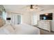 Bright primary bedroom with carpet flooring, ceiling fan and access to the backyard at 150 Barefoot Beach Way, Kissimmee, FL 34746