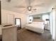 Bright bedroom featuring a ceiling fan, modern furnishings, and neutral decor at 150 Barefoot Beach Way, Kissimmee, FL 34746