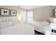Bright bedroom with carpet flooring featuring two beds with plush white bedding, and a large window at 150 Barefoot Beach Way, Kissimmee, FL 34746
