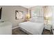 Bright bedroom featuring a large window, soft lighting, carpet, and modern decor at 150 Barefoot Beach Way, Kissimmee, FL 34746