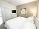 Cozy bedroom features a bed, TV, neutral decor, and a calm, relaxing atmosphere at 150 Barefoot Beach Way, Kissimmee, FL 34746