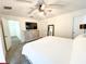 Comfortable bedroom with a dresser, mirror, and access to the rest of the home at 150 Barefoot Beach Way, Kissimmee, FL 34746