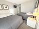 Neutral bedroom featuring two beds, stylish headboards, and lamps at 150 Barefoot Beach Way, Kissimmee, FL 34746