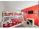 A fun bedroom featuring a bunk bed with red Mickey Mouse themed bedding and wallpaper accent wall at 150 Barefoot Beach Way, Kissimmee, FL 34746
