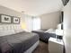 Bedroom featuring two beds, stylish headboards, and neutral decor at 150 Barefoot Beach Way, Kissimmee, FL 34746