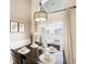 Bright dining area with large windows, a view of the backyard, and seating for four at 150 Barefoot Beach Way, Kissimmee, FL 34746