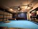 Spacious game room featuring a pool table, foosball, air hockey, and a themed accent wall at 150 Barefoot Beach Way, Kissimmee, FL 34746