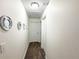 Hallway featuring neutral paint, mirrors, and doors to other rooms at 150 Barefoot Beach Way, Kissimmee, FL 34746