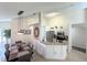Bright kitchen featuring stainless steel appliances and a granite-topped kitchen island and breakfast bar at 150 Barefoot Beach Way, Kissimmee, FL 34746