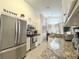 Bright kitchen with stainless steel appliances and granite countertops that flows into the dining area at 150 Barefoot Beach Way, Kissimmee, FL 34746