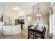 Open-concept kitchen and dining area with modern appliances and a breakfast bar at 150 Barefoot Beach Way, Kissimmee, FL 34746