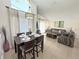 Comfortable living room featuring tall ceilings that flows into a dining area at 150 Barefoot Beach Way, Kissimmee, FL 34746
