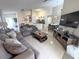 Open-concept living room seamlessly flows into dining and kitchen areas, perfect for modern living at 150 Barefoot Beach Way, Kissimmee, FL 34746