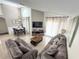 Bright living room featuring tall ceilings, lots of natural light and tile floors at 150 Barefoot Beach Way, Kissimmee, FL 34746