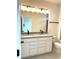 Bathroom featuring double vanity with granite countertop, modern lighting, and sleek fixtures at 15119 Grove Lake Dr, Winter Garden, FL 34787