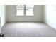 Cozy carpeted bedroom with two windows providing natural light and neutral color palette at 15119 Grove Lake Dr, Winter Garden, FL 34787