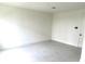Bright, neutral room with tile flooring and a door at 15119 Grove Lake Dr, Winter Garden, FL 34787