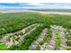 An aerial view of the property with mature trees, lake and community neighborhood in a lush setting at 1646 Song Sparrow Ct, Sanford, FL 32773