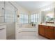 Bright bathroom featuring a large walk-in shower, a soaking tub, and a vanity with lots of storage at 1646 Song Sparrow Ct, Sanford, FL 32773