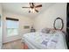Comfortable bedroom with a ceiling fan, a window, and a decorative mirror at 1646 Song Sparrow Ct, Sanford, FL 32773