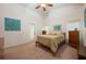Comfortable bedroom with neutral tones, a ceiling fan, and an outside door offering natural light at 1646 Song Sparrow Ct, Sanford, FL 32773