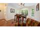 Bright breakfast nook with a wood table, four chairs, large windows, and wood floors at 1646 Song Sparrow Ct, Sanford, FL 32773