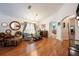 Cozy living room featuring hardwood flooring, decorative mirrors, modern furniture, and archway to the kitchen at 1646 Song Sparrow Ct, Sanford, FL 32773