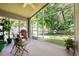 Screened porch overlooking a backyard with seating area, plants, and ample light at 1646 Song Sparrow Ct, Sanford, FL 32773