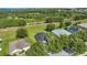 Birds-eye view of the property showcasing proximity to lush nature, lake, and manicured backyard at 189 Blackstone Creek Rd, Groveland, FL 34736