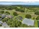 Aerial view of the home with a lush green backyard and beautiful landscaping at 189 Blackstone Creek Rd, Groveland, FL 34736