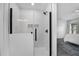 Sleek walk-in shower with glass enclosure, white tile, and modern black fixtures at 189 Blackstone Creek Rd, Groveland, FL 34736