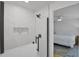 Modern bathroom featuring sleek glass shower with tile niche and dark hardware at 189 Blackstone Creek Rd, Groveland, FL 34736