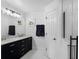 Stylish bathroom featuring double sinks, marble countertop, and elegant lighting at 189 Blackstone Creek Rd, Groveland, FL 34736