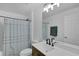 Full bathroom with a shower/tub combo, wood vanity, and black hardware at 189 Blackstone Creek Rd, Groveland, FL 34736