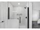 Modern walk-in shower with glass enclosure, white tile, and contemporary black fixtures at 189 Blackstone Creek Rd, Groveland, FL 34736