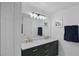 Bathroom features double sink vanity, and modern lighting fixtures at 189 Blackstone Creek Rd, Groveland, FL 34736
