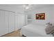 Bright bedroom with a ceiling fan, light wood floors, and ample closet space at 189 Blackstone Creek Rd, Groveland, FL 34736