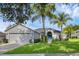 Inviting single-story home with a well-manicured lawn and blue front door at 189 Blackstone Creek Rd, Groveland, FL 34736