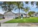 Inviting single-story home with a well-manicured lawn and blue front door at 189 Blackstone Creek Rd, Groveland, FL 34736