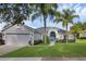 Charming single-story home boasts a lush lawn, mature trees, and inviting curb appeal at 189 Blackstone Creek Rd, Groveland, FL 34736