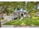 Charming single-story home boasts a lush lawn, mature trees, and inviting curb appeal at 189 Blackstone Creek Rd, Groveland, FL 34736