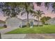 Inviting single-story home with a well-manicured lawn and blue front door at 189 Blackstone Creek Rd, Groveland, FL 34736