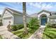 Charming home with a blue front door, lush landscaping, and a manicured lawn at 189 Blackstone Creek Rd, Groveland, FL 34736