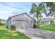 Spacious two-car garage with a long driveway and manicured landscaping at 189 Blackstone Creek Rd, Groveland, FL 34736