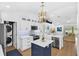 Updated kitchen with white cabinets, a center island, and modern appliances in an open layout at 189 Blackstone Creek Rd, Groveland, FL 34736