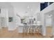 Modern, all-white kitchen with marble countertops, a center island, and stylish seating at 189 Blackstone Creek Rd, Groveland, FL 34736