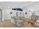 Spacious living room featuring wood floors, a high ceiling, and access to the kitchen at 189 Blackstone Creek Rd, Groveland, FL 34736