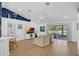 Inviting living room featuring vaulted ceiling, natural lighting, and access to outdoor patio at 189 Blackstone Creek Rd, Groveland, FL 34736
